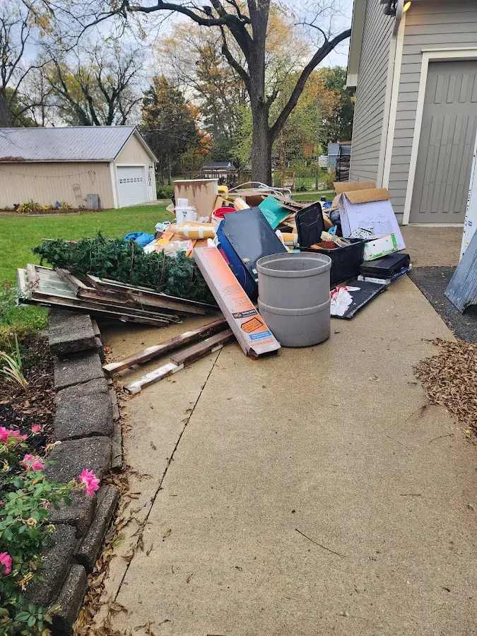 Dumpster being loaded with debris for Demolition Dumpster Rental in Tucker